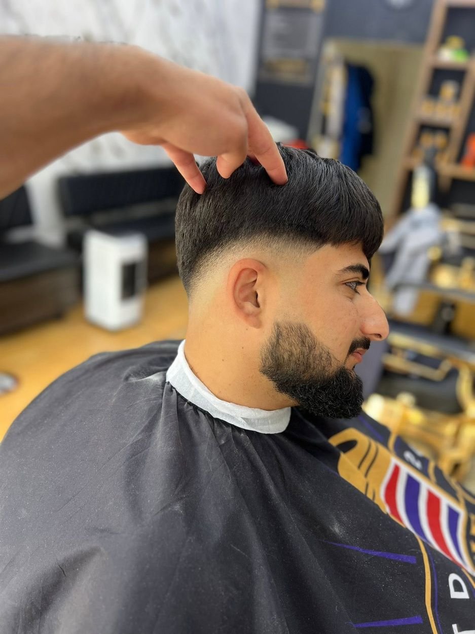 Low fade with a full, shaped beard